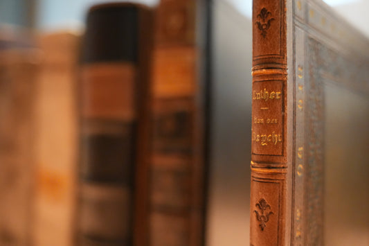 An image of rare sixteenth-century books with a 1522 first edition of Martin Luther in the foreground