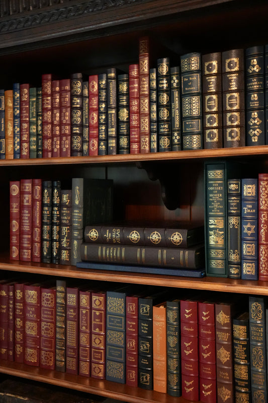 An antique bookcase beautifully arranged with Easton Press leatherbound books